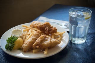 Plate Of Fish And Chips With A Drink