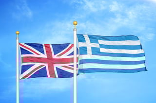 UK and Greece flags waving outdoors