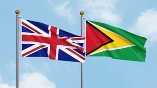 United Kingdom and Guyana flags waving