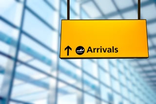 Yellow airport arrivals direction sign