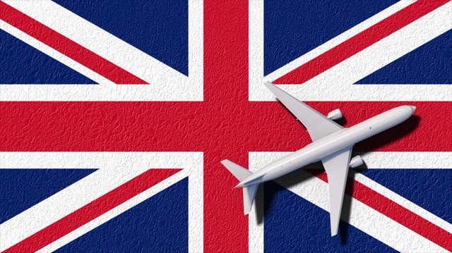 Airplane Over Uk Flag Travel Concept