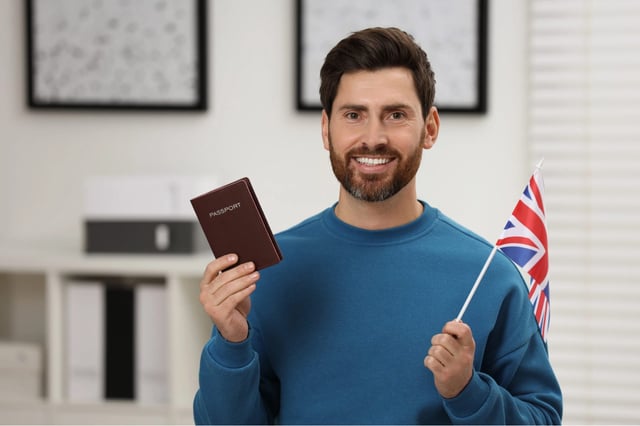 Happy Man With Passport And Flag Of United Kingdom Indoors