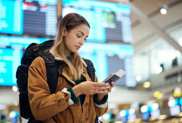 Passport And Woman With Phone At Airport Lobby