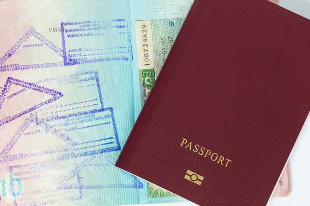 Passport Beside Numerous Travel Visa Stamps