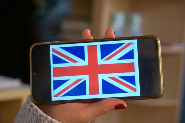 Woman Holding A Phone With The Uk Flag