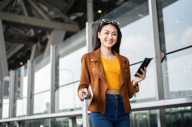 Woman Traveller Holding Passport And Smartphone