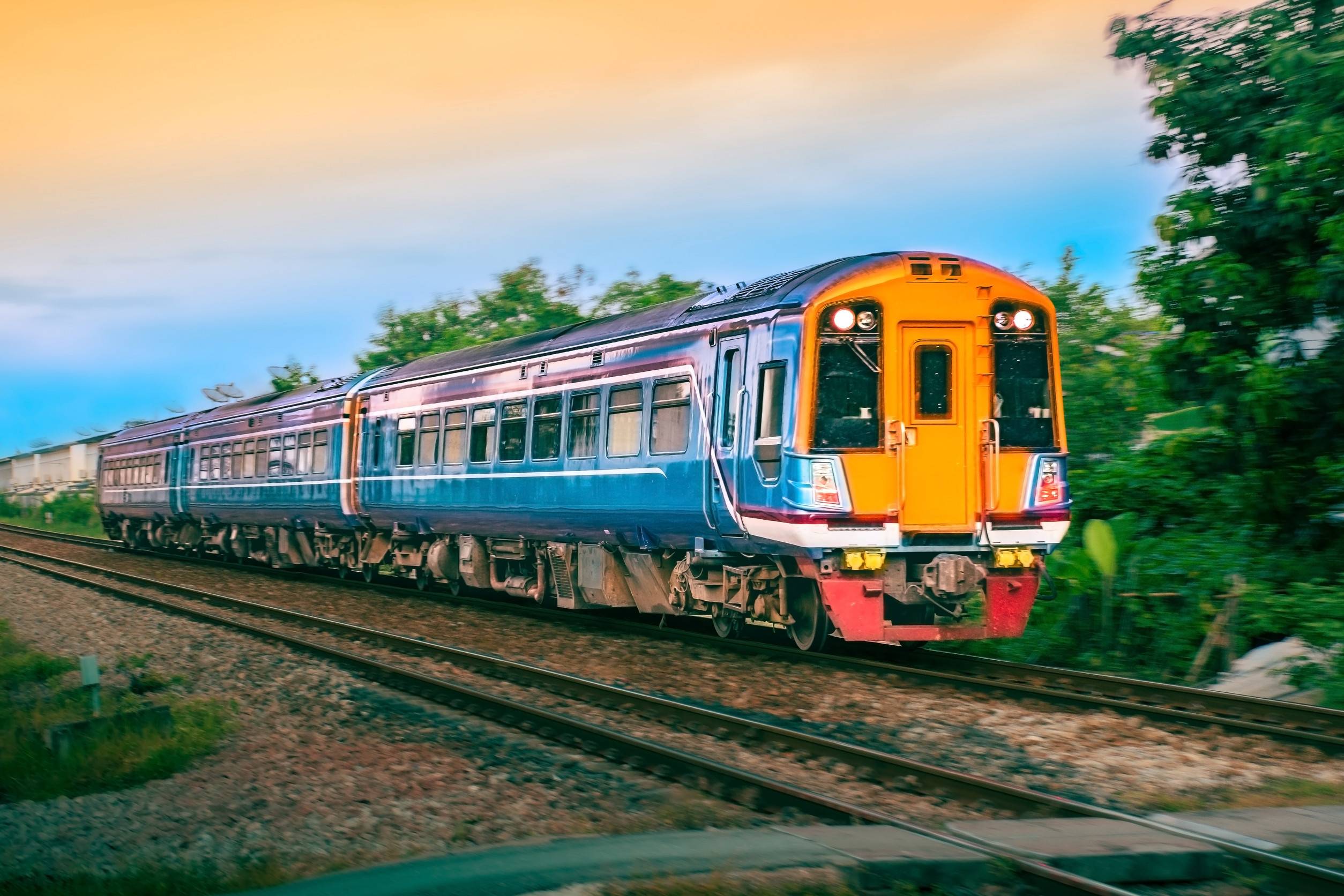 Blue And Orange Passenger Train On Tracks
